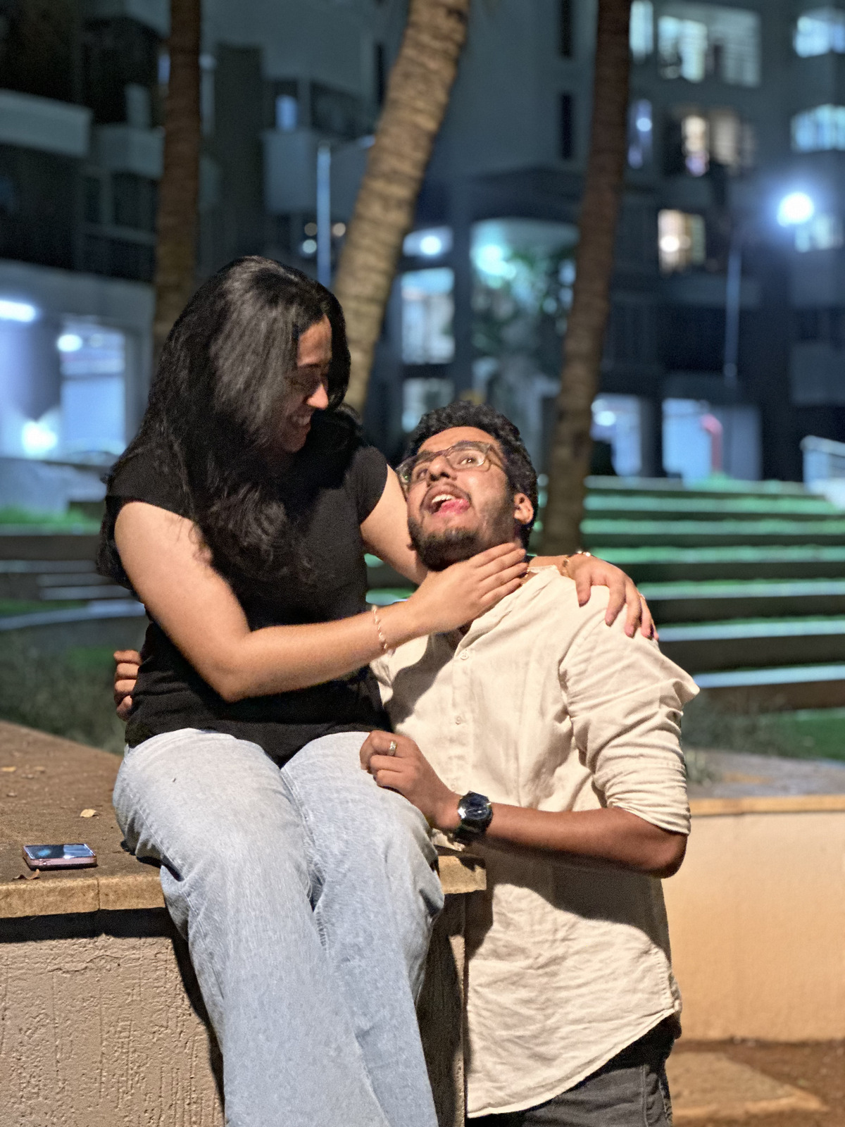 The couple laughing together on an evening out