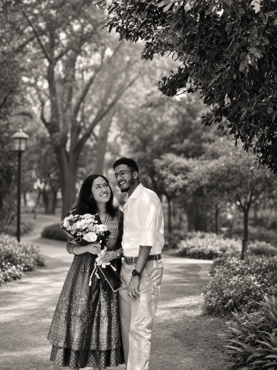 Nigel and Joanna laughing together on a tree-lined path