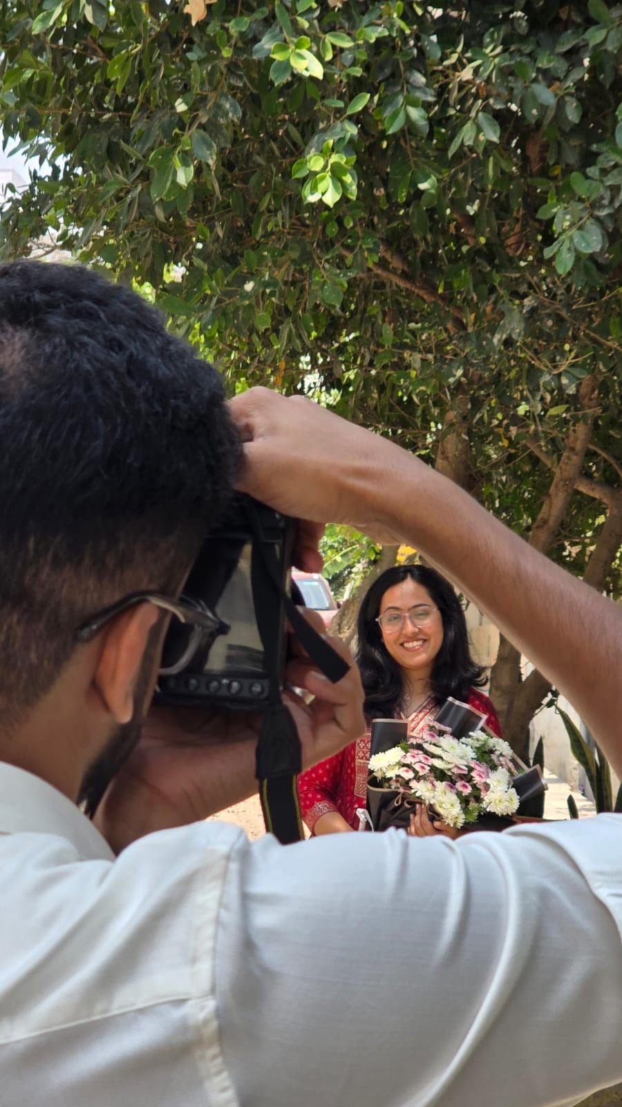 Joanna with flowers being photographed